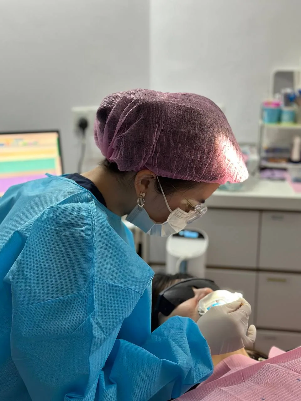 Clinician carrying out an in-office whitening session at our Bukit Jalil clinic, applying professional-grade gel under supervision