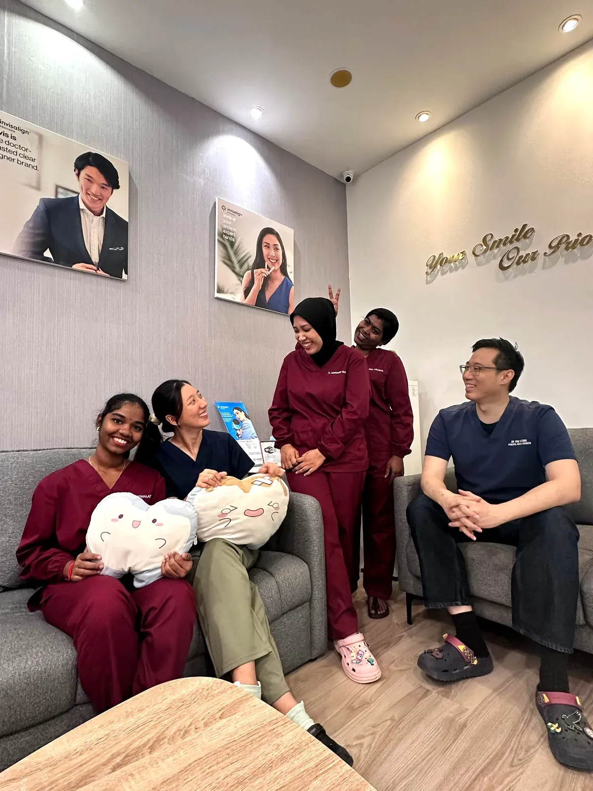The Lau & Su Partners Dental team gathered on the lounge sofa for a group photo at the Bukit Jalil clinic