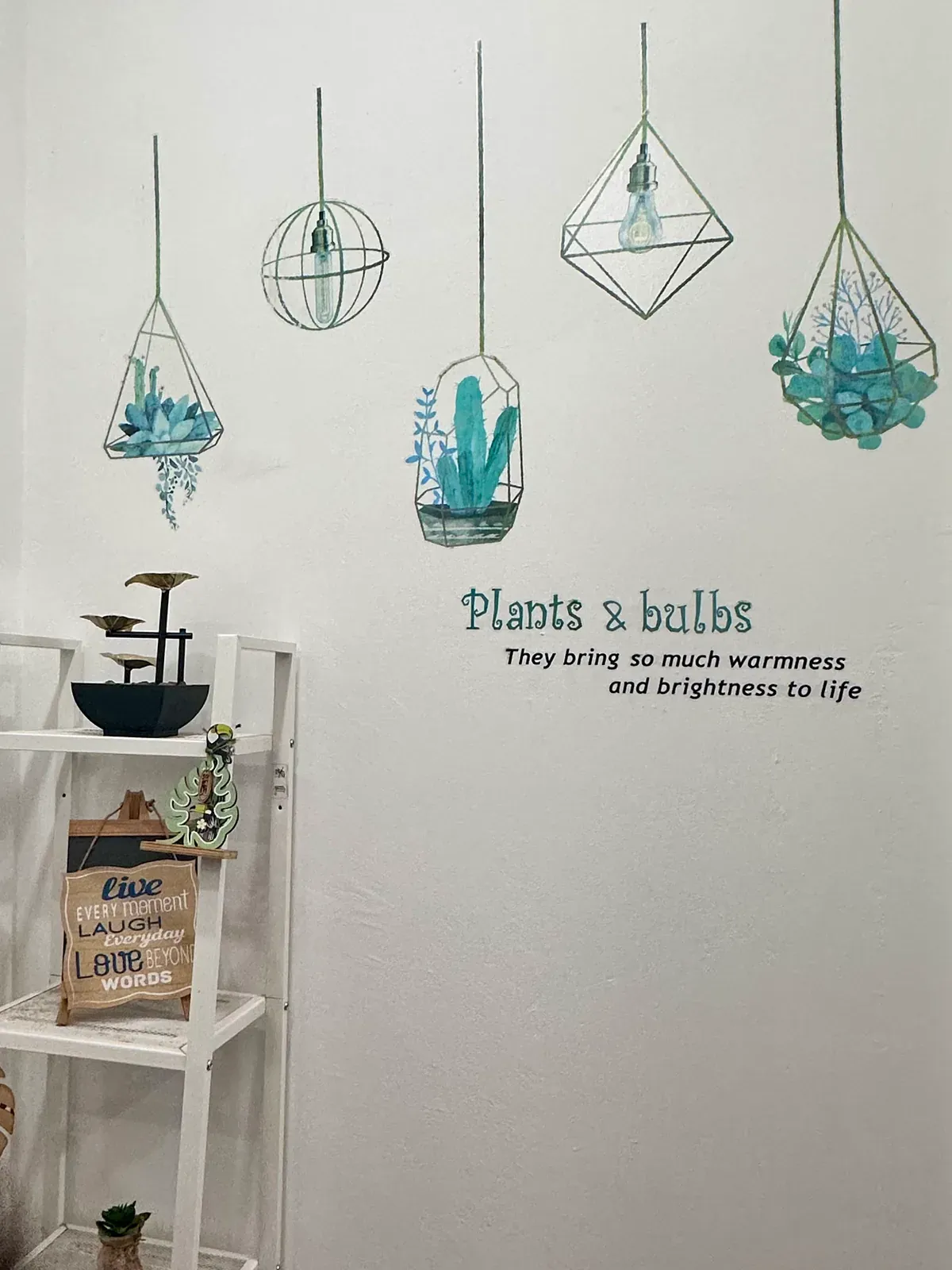 Plants and bulbs feature wall with hanging geometric terrariums and greenery in the Lau & Su Partners Dental clinic, Bukit Jalil